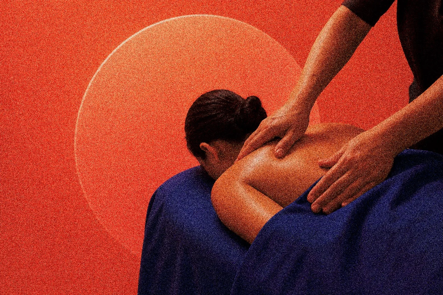 A massage therapist working a client's back, on an orange background